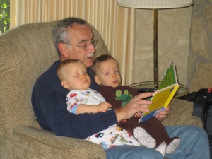 Grandpa reads them a story